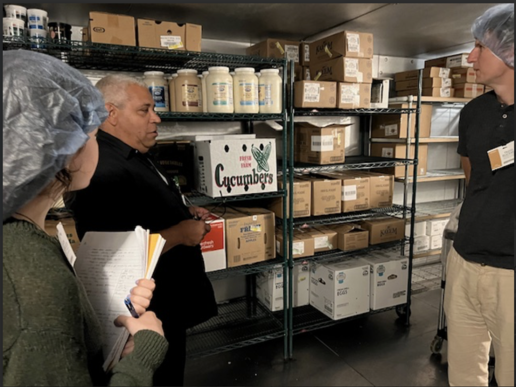 Three people in an industrial kitchen